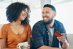 man and women with debit card